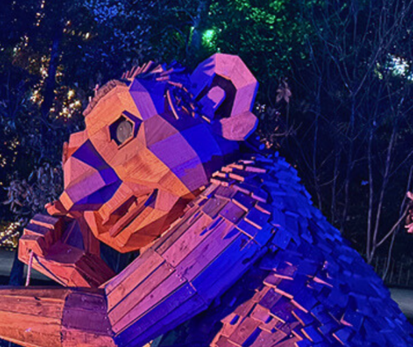 Close up of a wooden troll statue in the trees